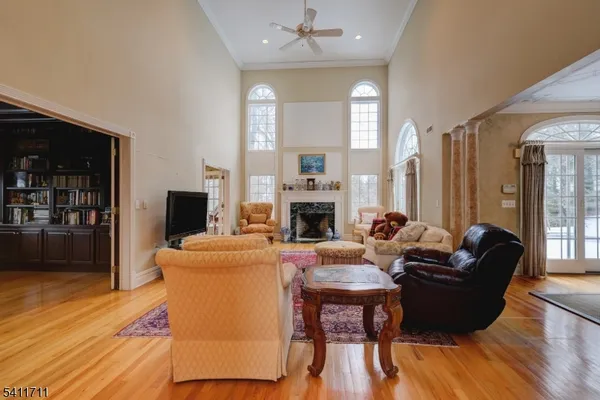 a living room with furniture a fireplace and a wooden floor