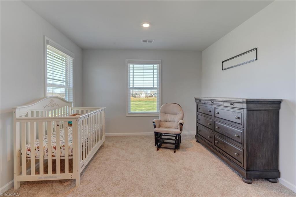 5001 Alton Drive Oak Ridge, NC 27310 - Photo 23 of 39 Sitting room in the primary is currently being used as a nursery. Great flex space.
