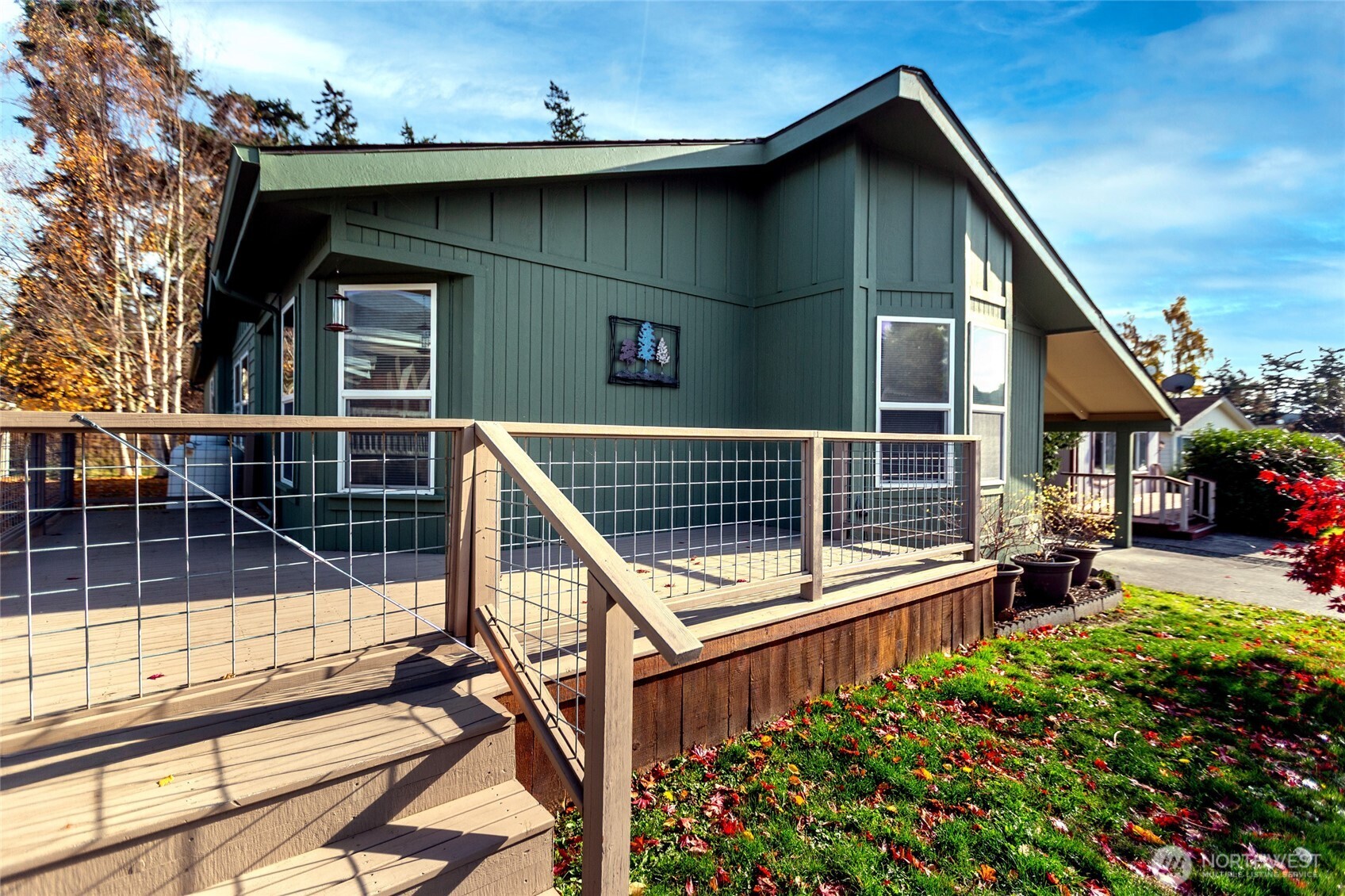 1785 Douglas Road, Unit 30 Friday Harbor, WA 98250 - Photo 2 of 32 a view of a roof deck with table and chairs with wooden floor and fence