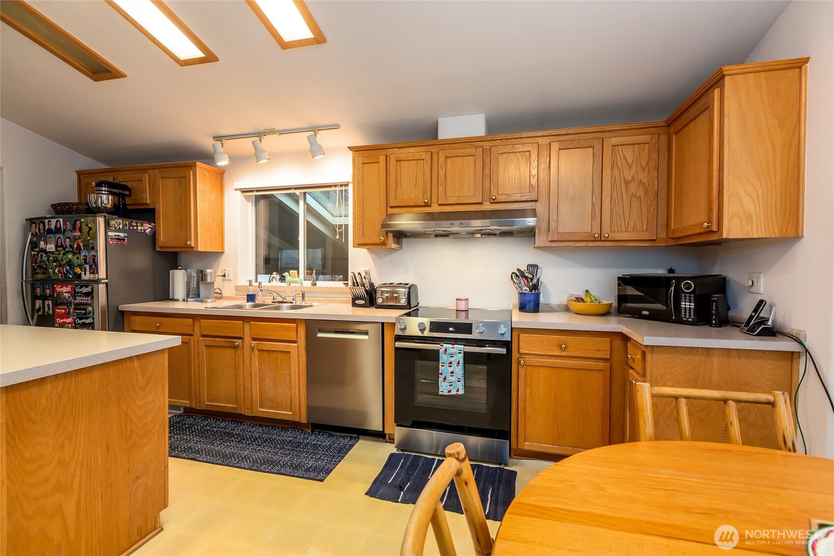 1785 Douglas Road, Unit 30 Friday Harbor, WA 98250 - Photo 7 of 32 a kitchen with stainless steel appliances granite countertop a sink and cabinets
