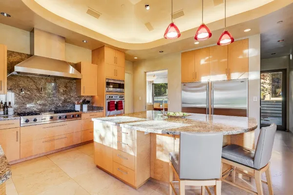 a living room with furniture and large windows