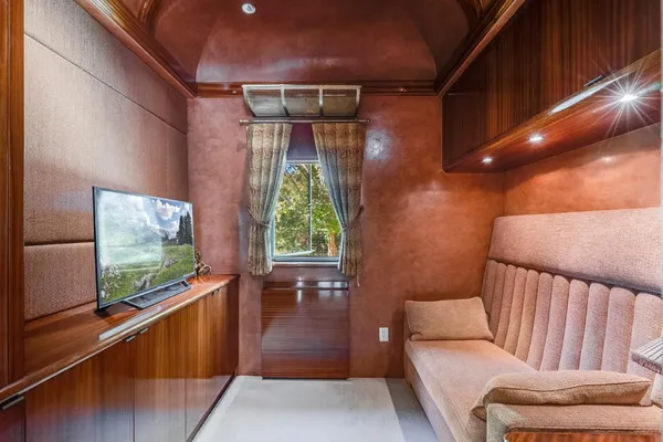 a living room with furniture and a book shelf