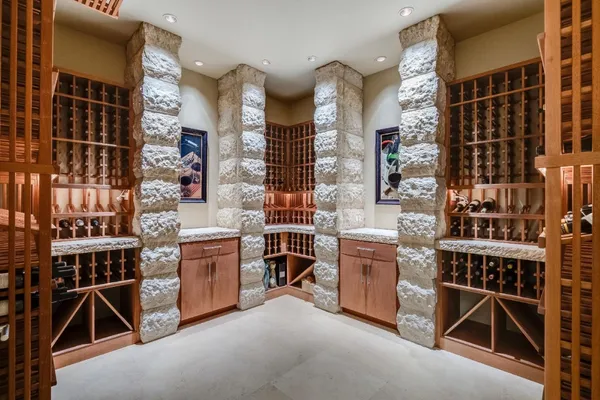 a dining hall with stainless steel appliances kitchen island granite countertop a dining table chairs and a counter top space