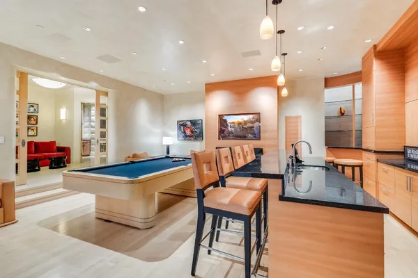 a view of a dining room with furniture and a potted plant