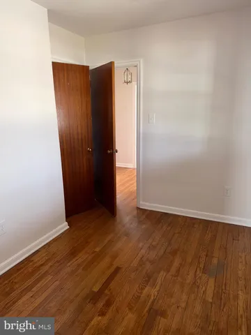 an empty room with wooden floor