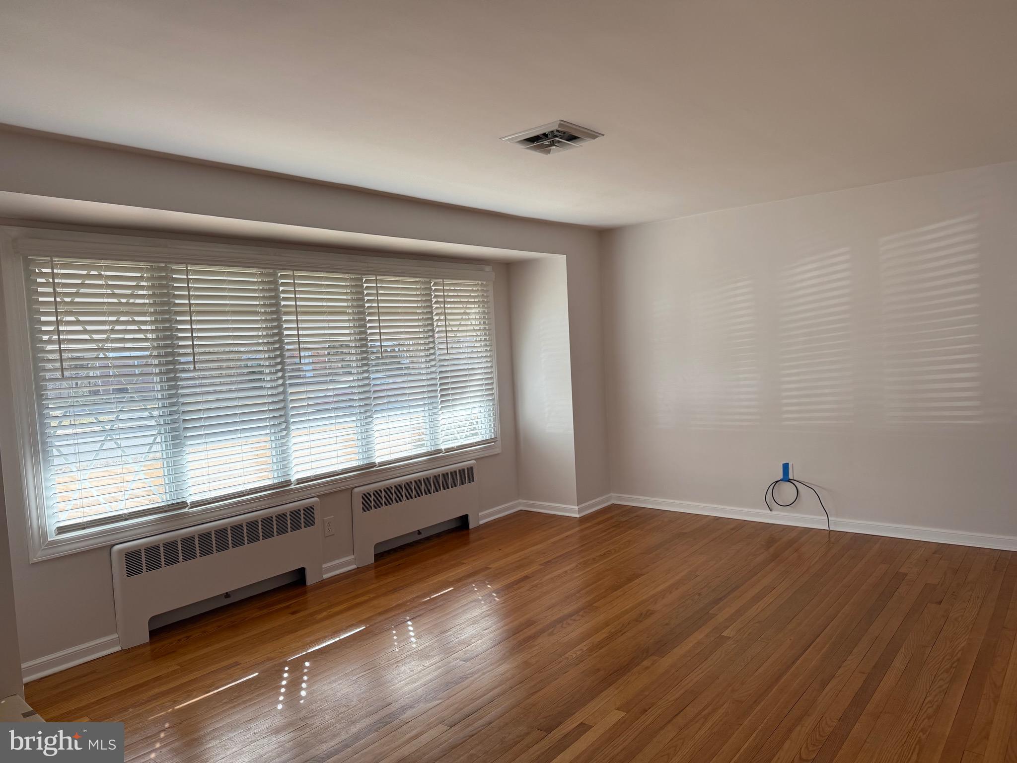 661 Grape Street Hammonton, NJ 08037 - Photo 2 of 14 a view of an empty room with wooden floor and a window