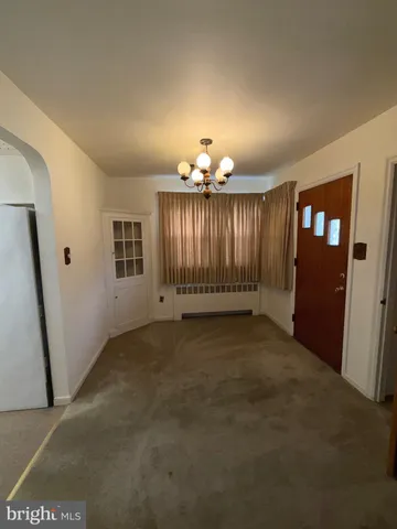 an empty room with windows and hardwood floor