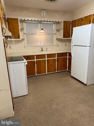 a kitchen with stainless steel appliances a refrigerator and a sink