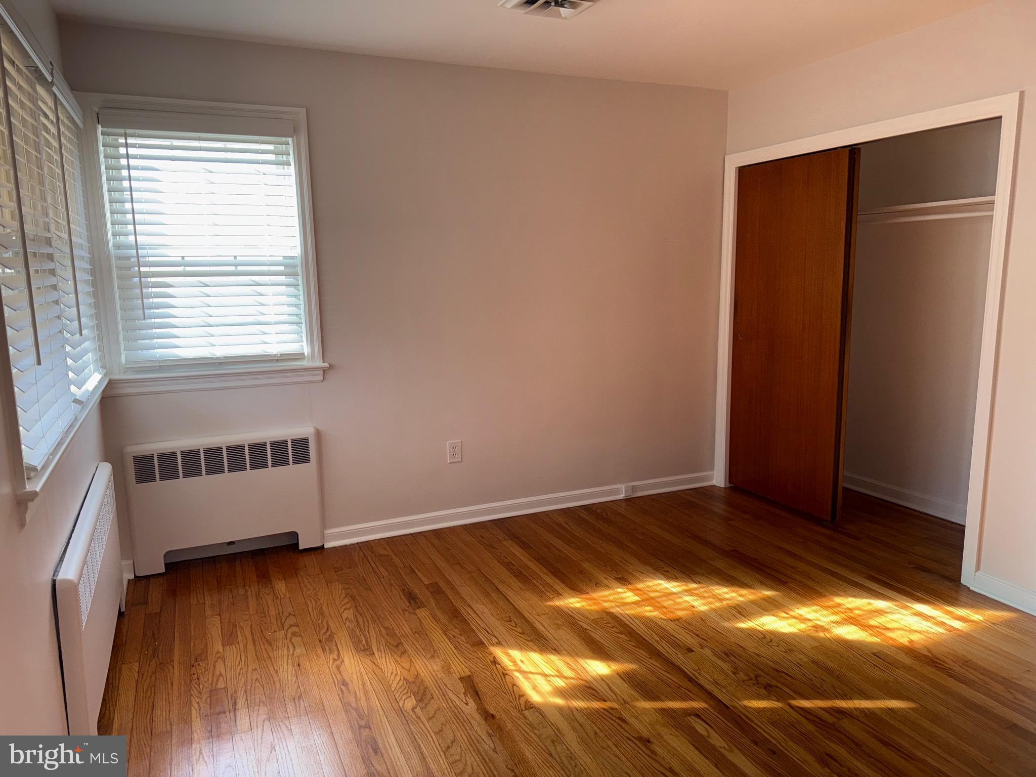 661 Grape Street Hammonton, NJ 08037 - Photo 9 of 14 an empty room with wooden floor and windows