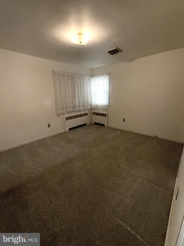 an empty room with a empty space and windows