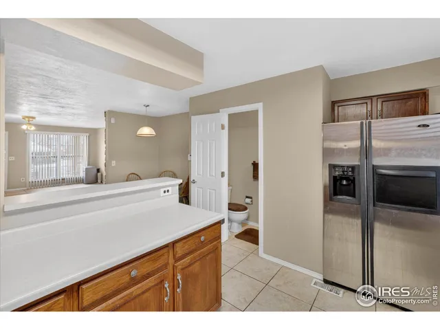 a bed sitting in a bedroom next to a bathroom with a sink
