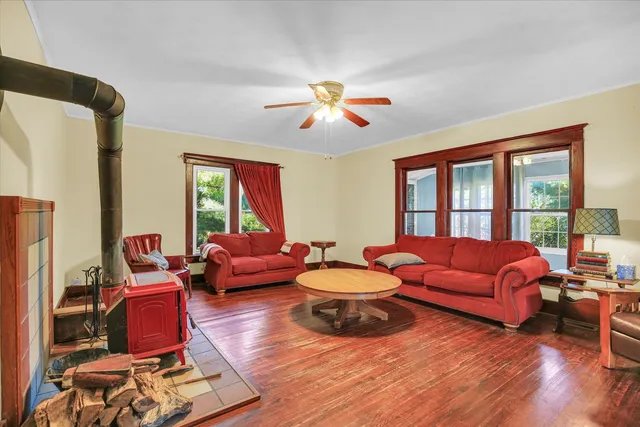 a living room with furniture fireplace and a large window