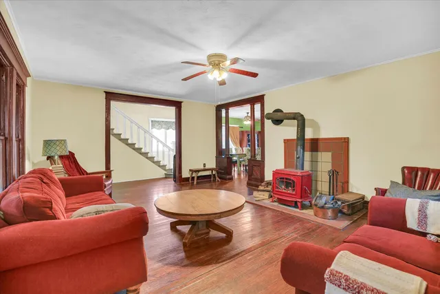 a living room with furniture a flat screen tv and a large window