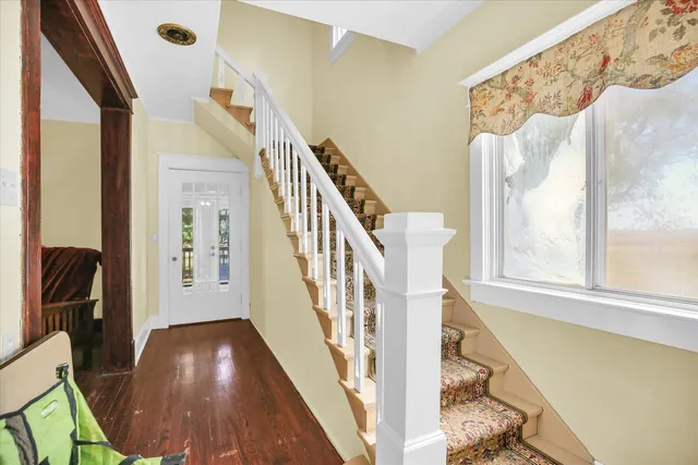 a view of front door with furniture and stairs