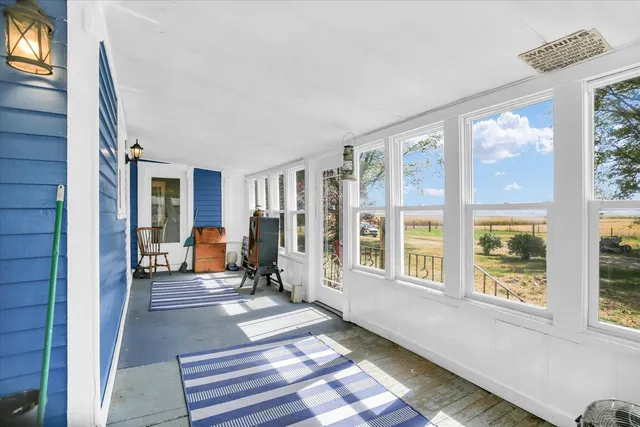 a living room with furniture and large windows