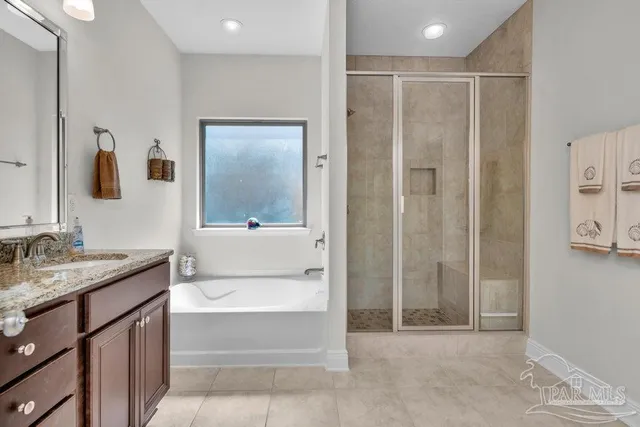 a bathroom with a shower a sink and a mirror