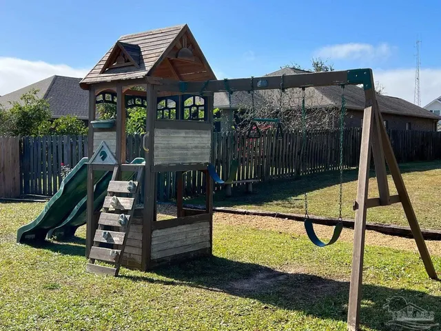 a view of a roof deck with wooden fence and a floor to ceiling window
