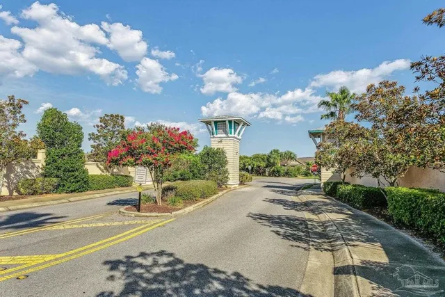a front view of a house with a yard and a garden