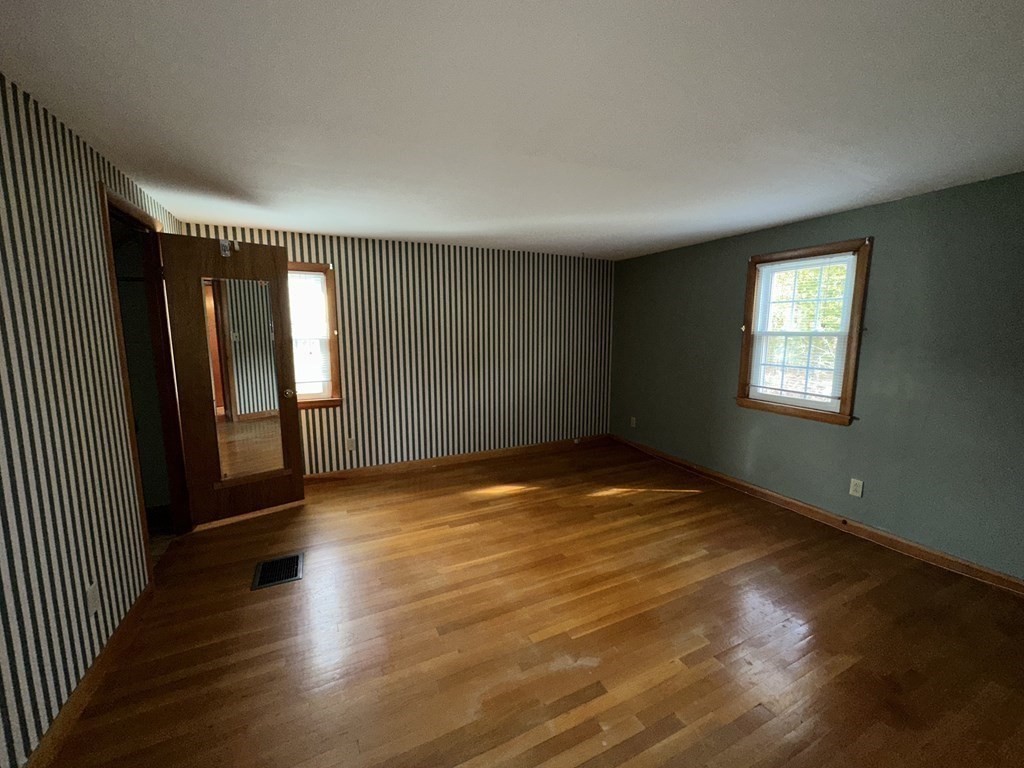 4 Manwell Road Chelmsford, MA 01824 - Photo 13 of 22 an empty room with wooden floor and windows