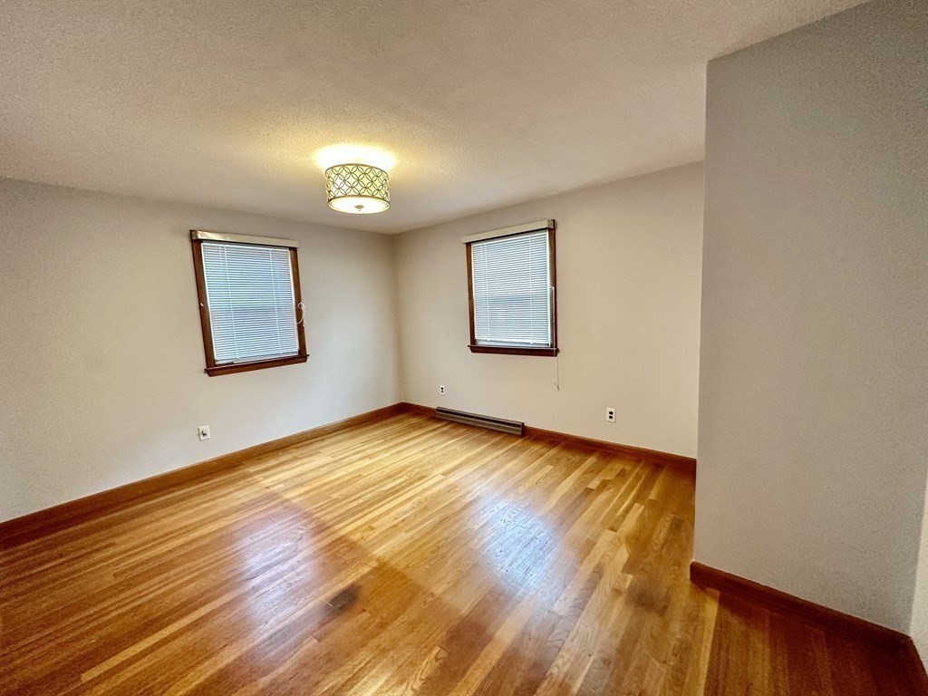 4 Manwell Road Chelmsford, MA 01824 - Photo 15 of 22 a view of empty room with wooden floor and fan