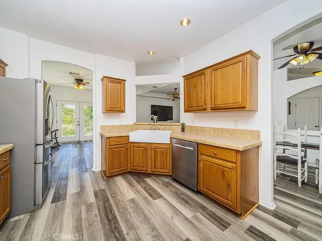 a living room with furniture and a refrigerator