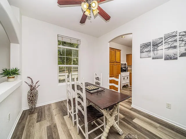 a living room with furniture kitchen area and a rug