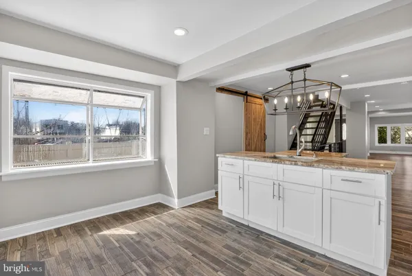 a spacious bathroom with a sink and a mirror