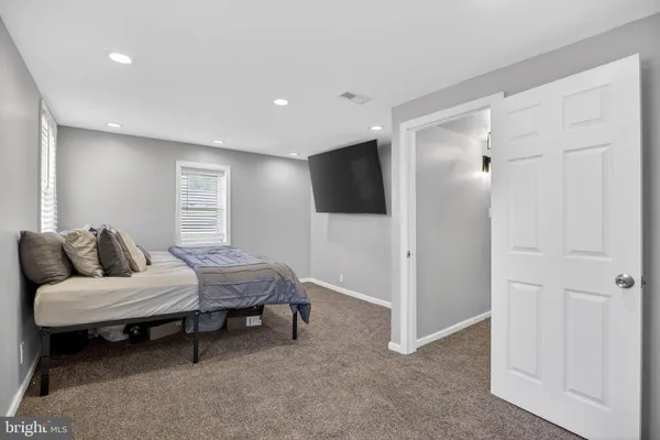 a bedroom with furniture and a bathroom