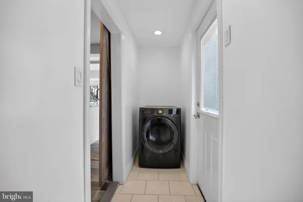 a bathroom with a sink and a washer dryer