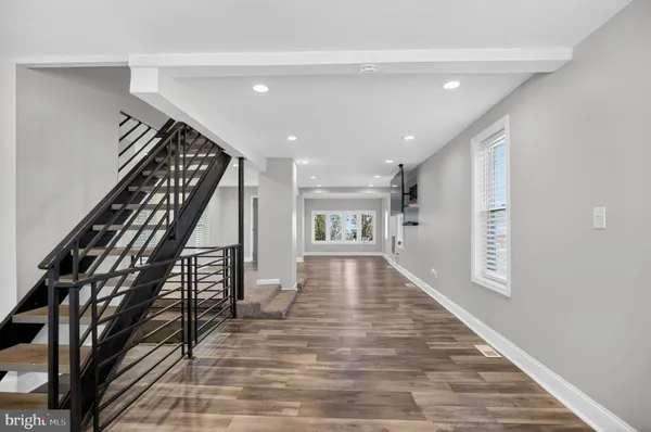 a view of entryway and hall with wooden floor