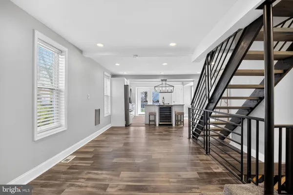 a view of an empty room with stairs and a window