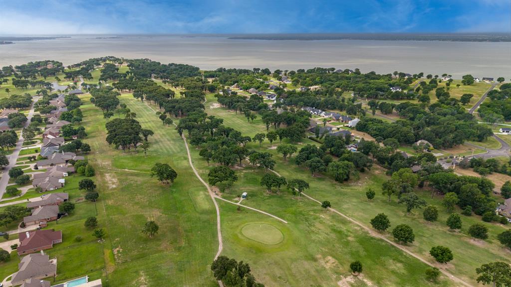 101 Lighthouse Lane Mabank, TX 75143 - Photo 37 of 40 Aerial perspective showcasing a sprawling golf course community with extensive green space and mature trees,Cedar Creek Country Club