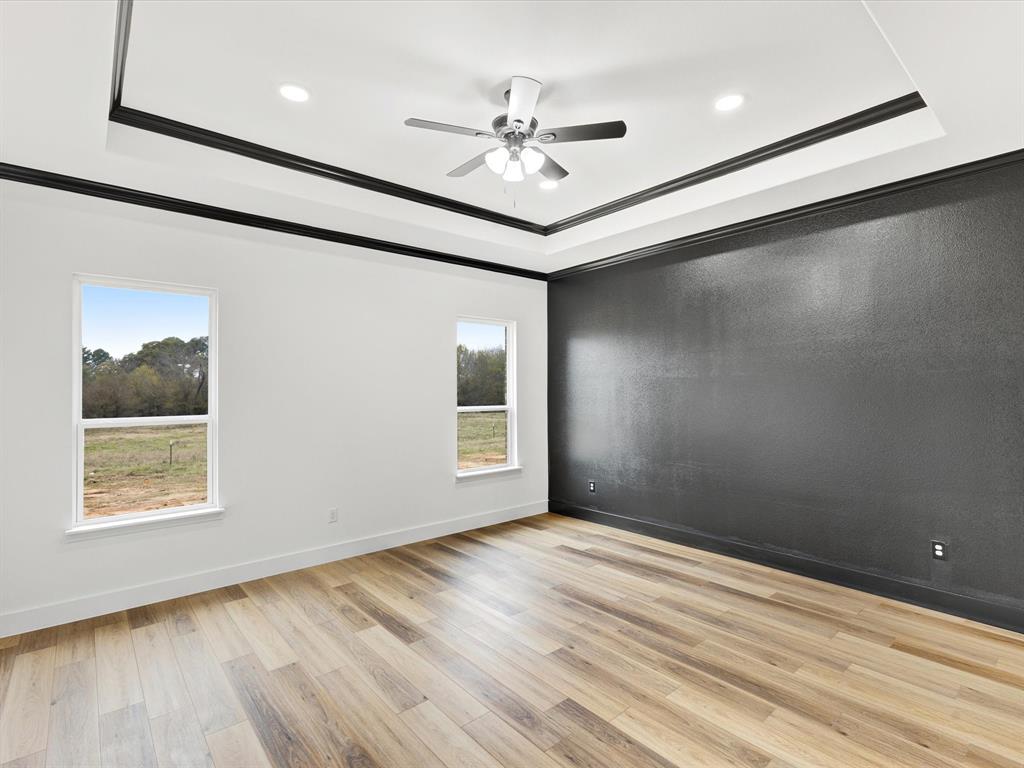 544 Shepherd Road Combine, TX 75159 - Photo 20 of 36 Empty room featuring light wood finished floors, ceiling fan, healthy amount of natural light, ornamental molding, and recessed lighting
