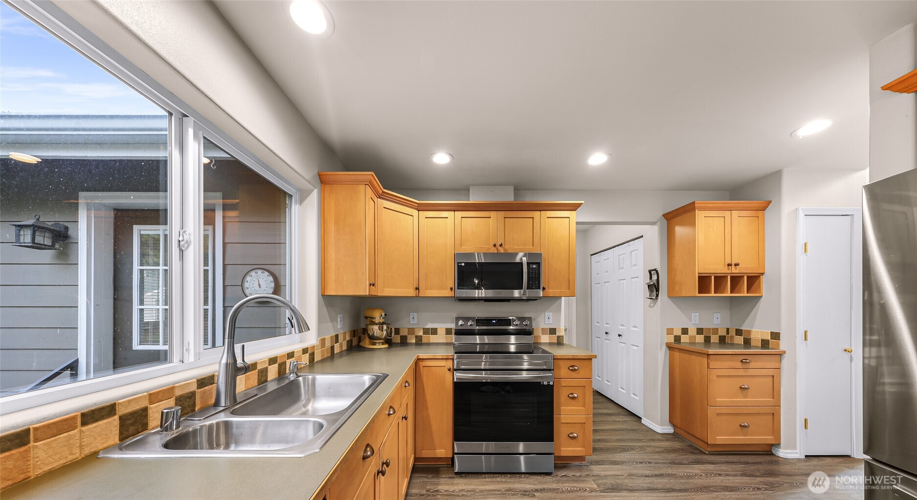 2976 Upland Way Ferndale, WA 98248 - Photo 12 of 38 a kitchen with stainless steel appliances a sink a stove and a refrigerator