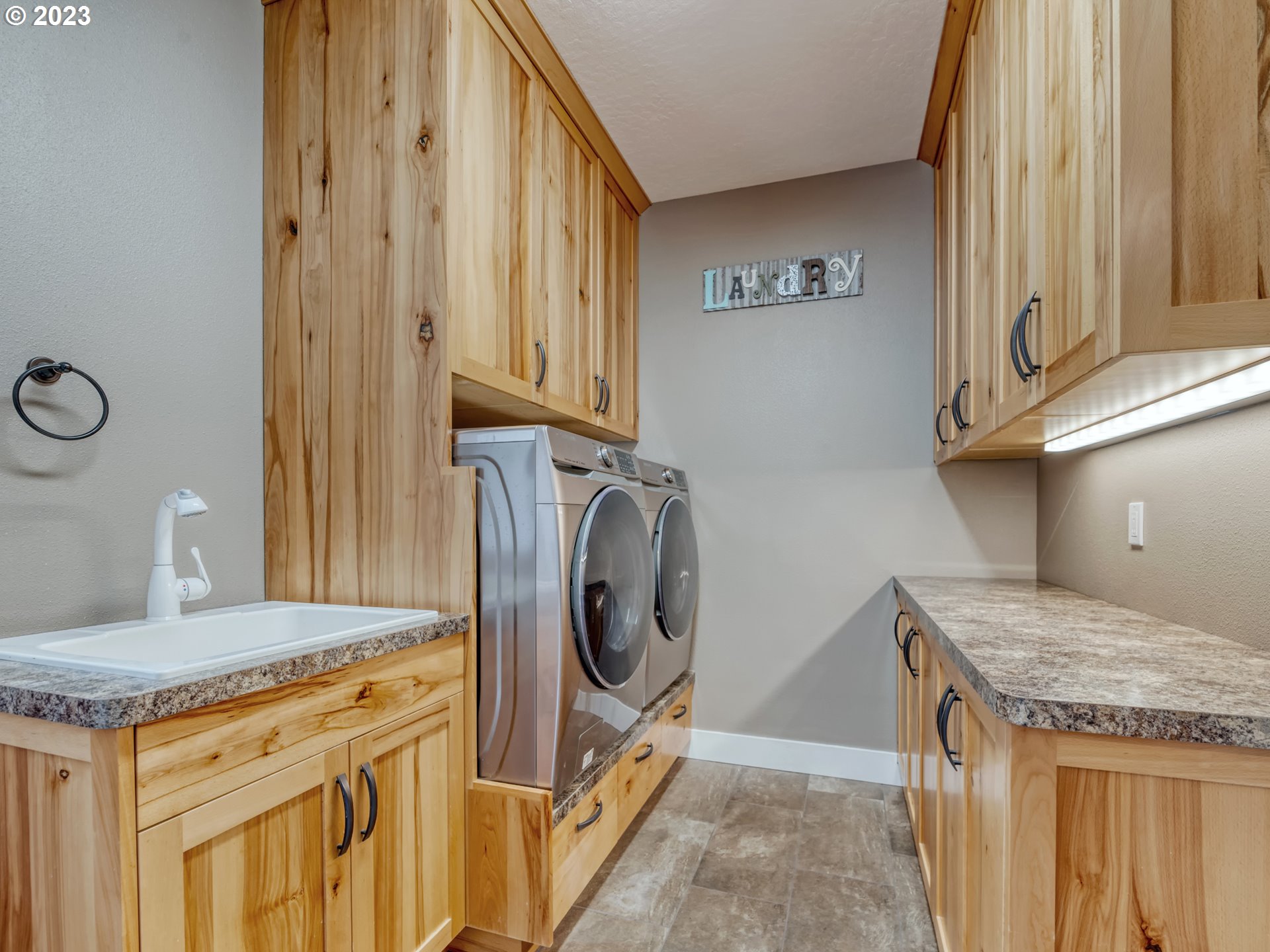 27876 Lady Slipper Loop Eugene, OR 97405 - Photo 14 of 45 a kitchen with granite countertop a sink a washer and dryer