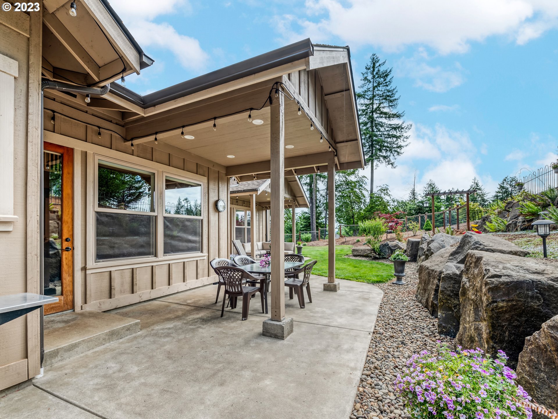 27876 Lady Slipper Loop Eugene, OR 97405 - Photo 41 of 45 a view of a porch with furniture and garden