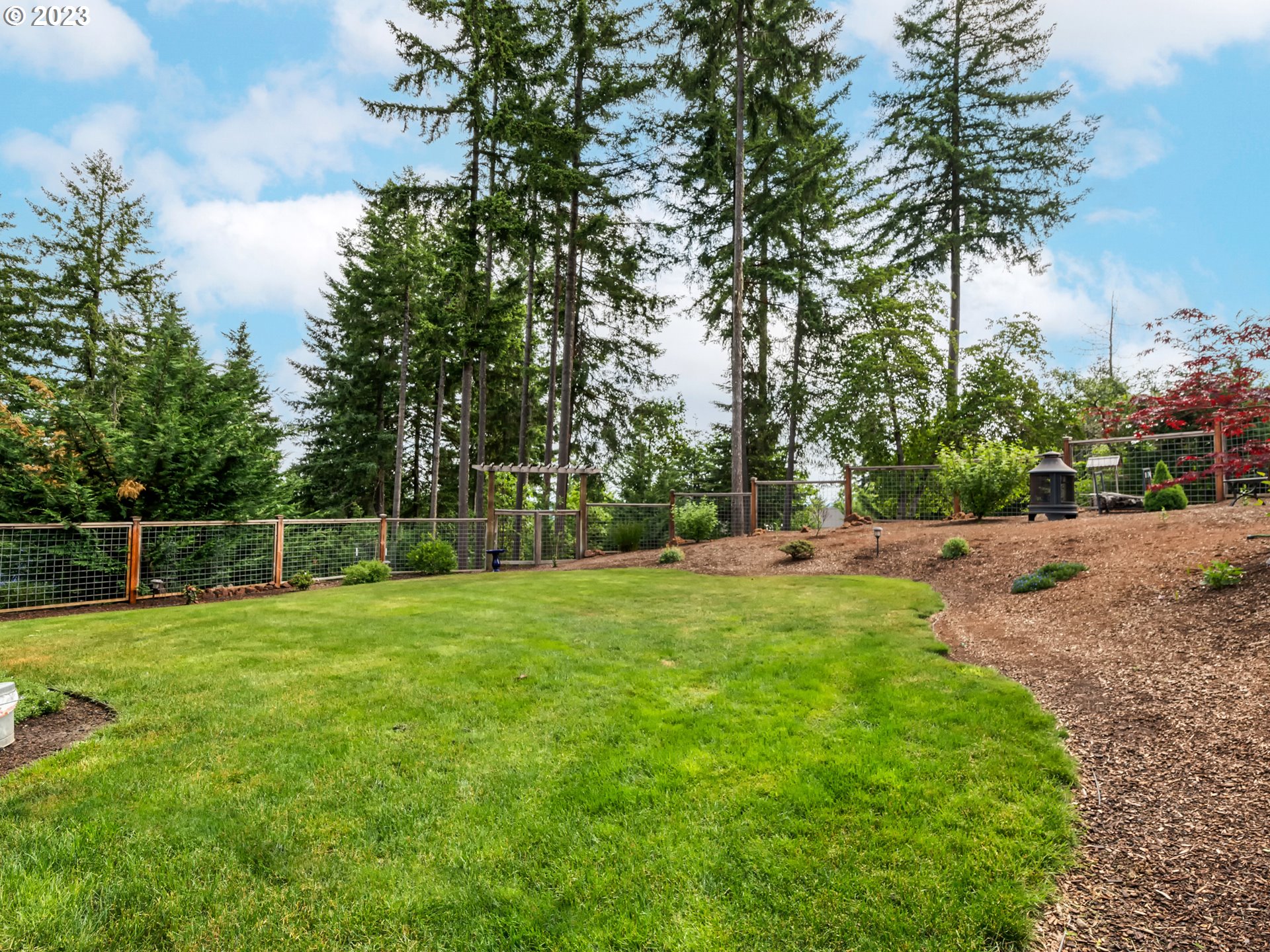 27876 Lady Slipper Loop Eugene, OR 97405 - Photo 43 of 45 a backyard of a house with lots of green space