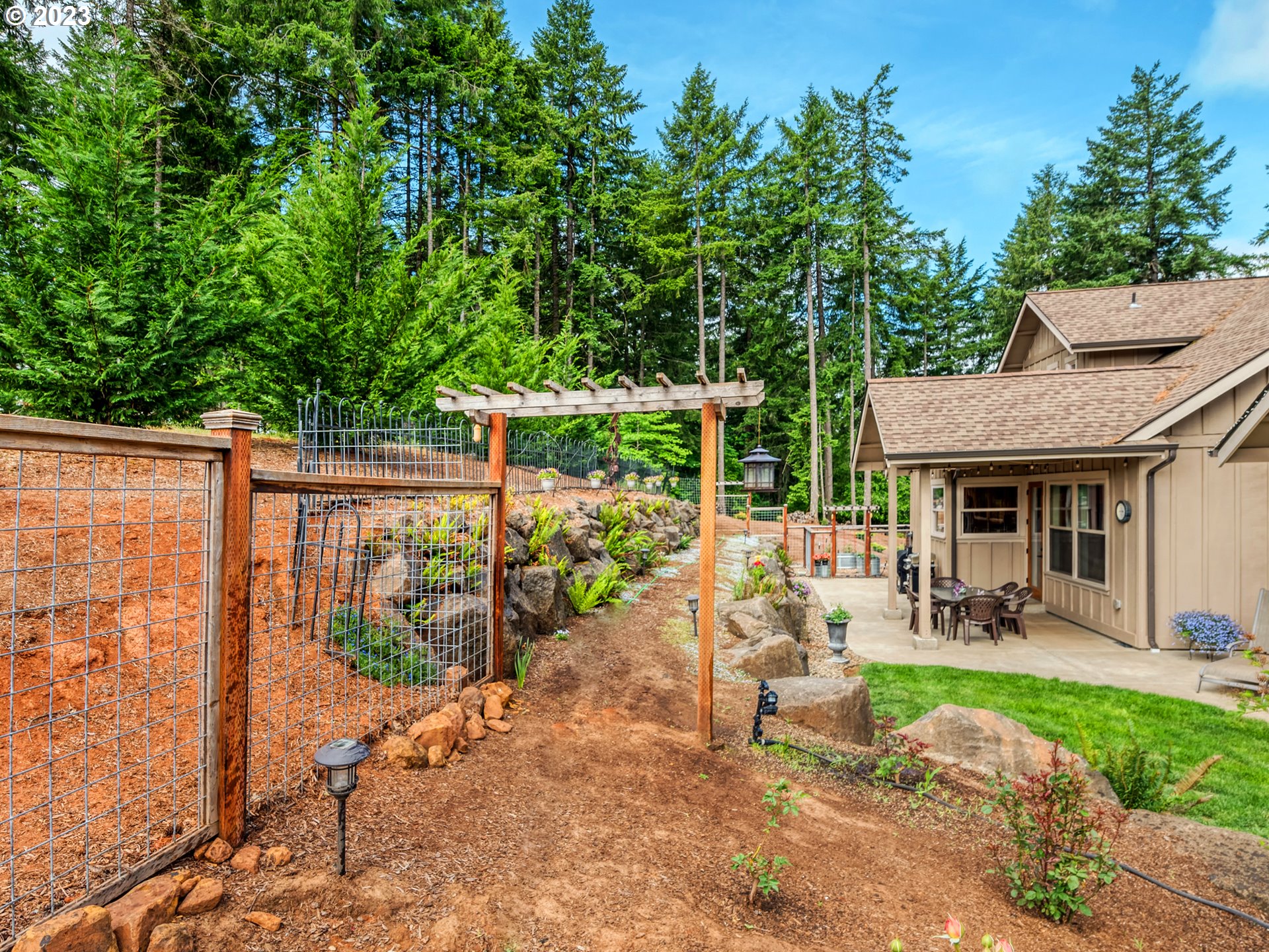 27876 Lady Slipper Loop Eugene, OR 97405 - Photo 45 of 45 a view of a patio with table and chairs potted plants with wooden fence