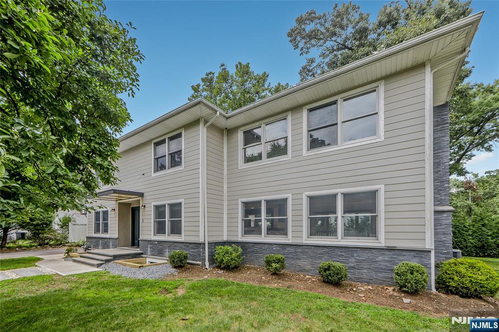 3 Laurel Road Demarest, NJ 07627 - Photo 14 of 43 a front view of a house with garden and plants