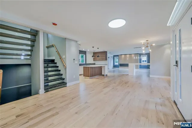 a view of a kitchen with wooden floor and stairs