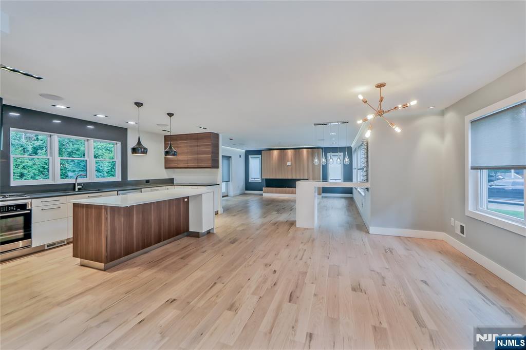 3 Laurel Road Demarest, NJ 07627 - Photo 25 of 43 a kitchen with stainless steel appliances kitchen island wooden floors wooden cabinets and entryway