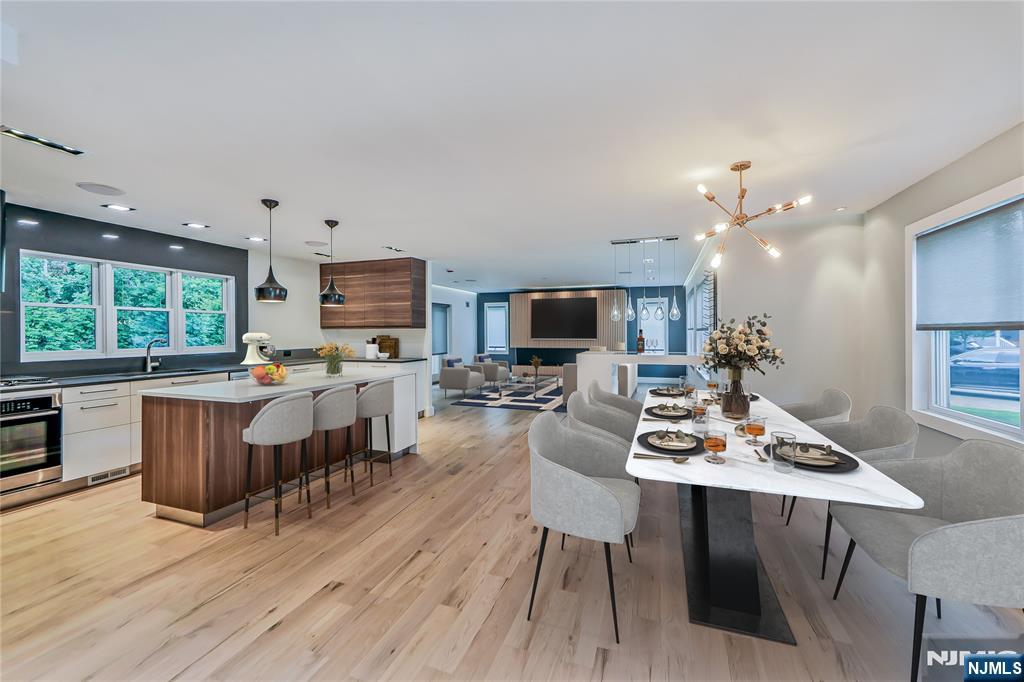 3 Laurel Road Demarest, NJ 07627 - Photo 26 of 43 a open dining room with kitchen island furniture a chandelier wooden floor and a view