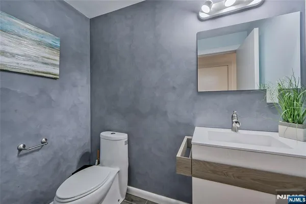 a bathroom with a sink a toilet and mirror