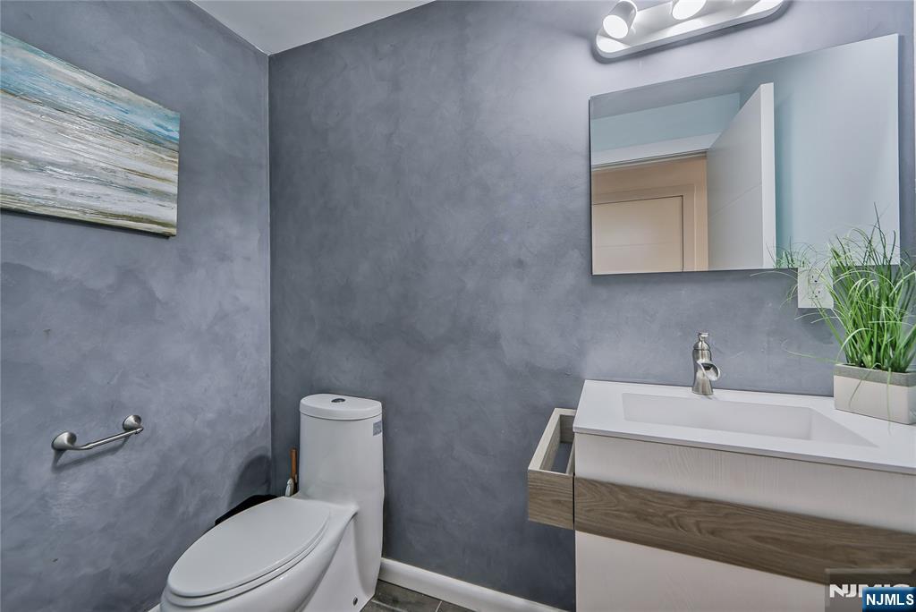 3 Laurel Road Demarest, NJ 07627 - Photo 29 of 43 a bathroom with a sink a toilet and mirror