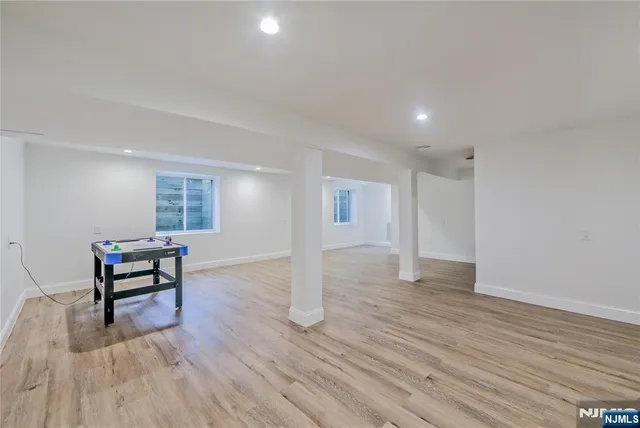 a view of a livingroom with wooden floor and furniture