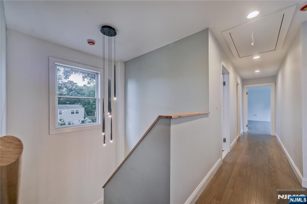 3 Laurel Road Demarest, NJ 07627 - Photo 34 of 43 a view of hallway with stairs and wooden floor