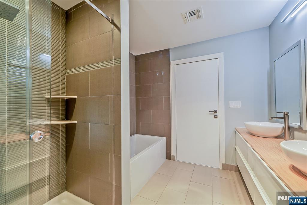 3 Laurel Road Demarest, NJ 07627 - Photo 41 of 43 a bathroom with a tub sink and mirror