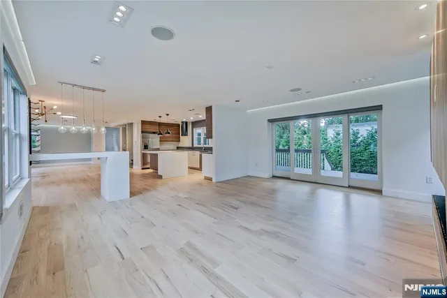 a view of a living room hardwood floor and a kitchen