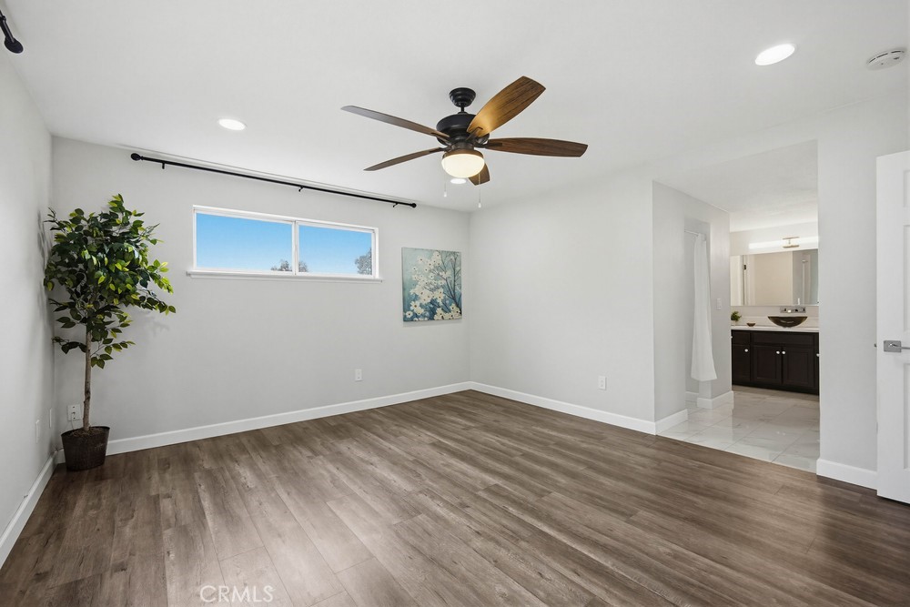 2256 Kentwood Drive Riverside, CA 92507 - Photo 19 of 26 a view of a big room with wooden floor and a chandelier fan