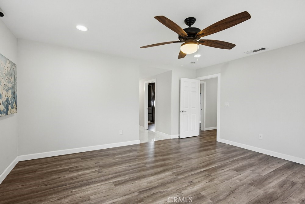 2256 Kentwood Drive Riverside, CA 92507 - Photo 20 of 26 an empty room with wooden floor and ceiling fan